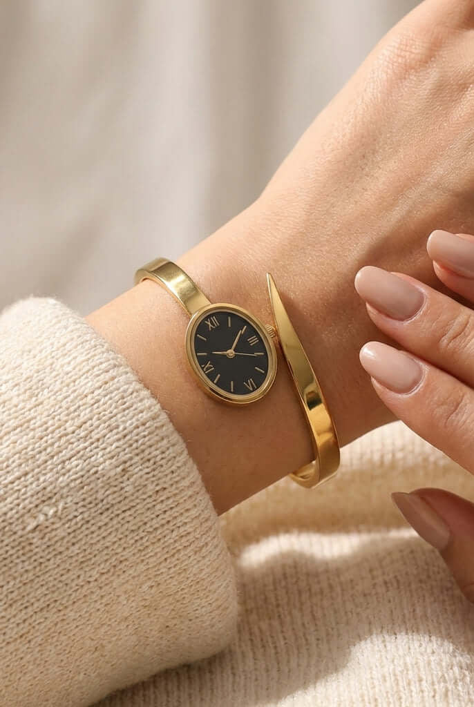 Minimal gold watch bangle - Pakistani women's elegant jewelry with oval black dial and Roman numerals in slim gold tone front view