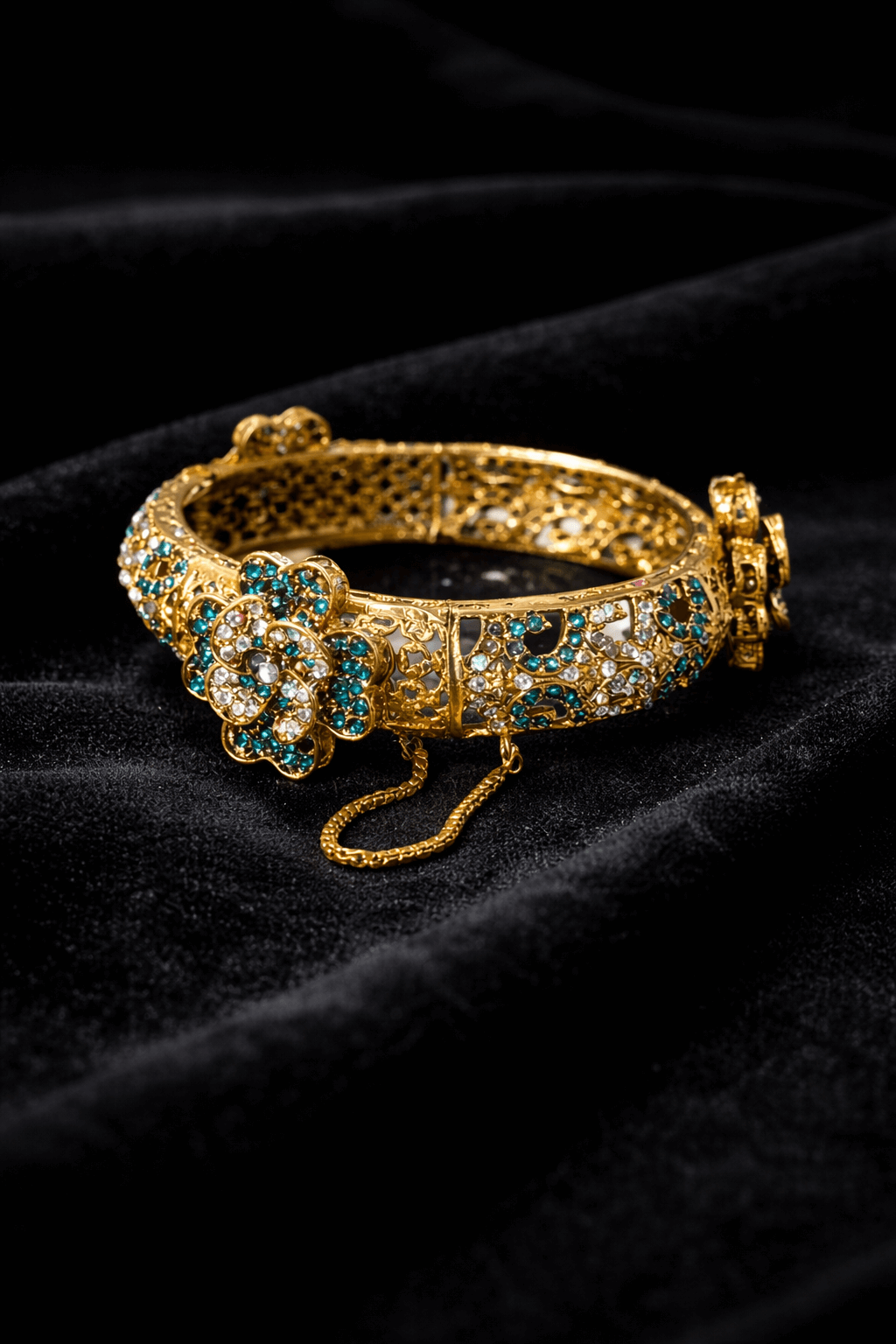 Royal emerald floral gold bangle - Pakistani women's luxury bridal jewelry with filigree detailing and emerald teal stones front view