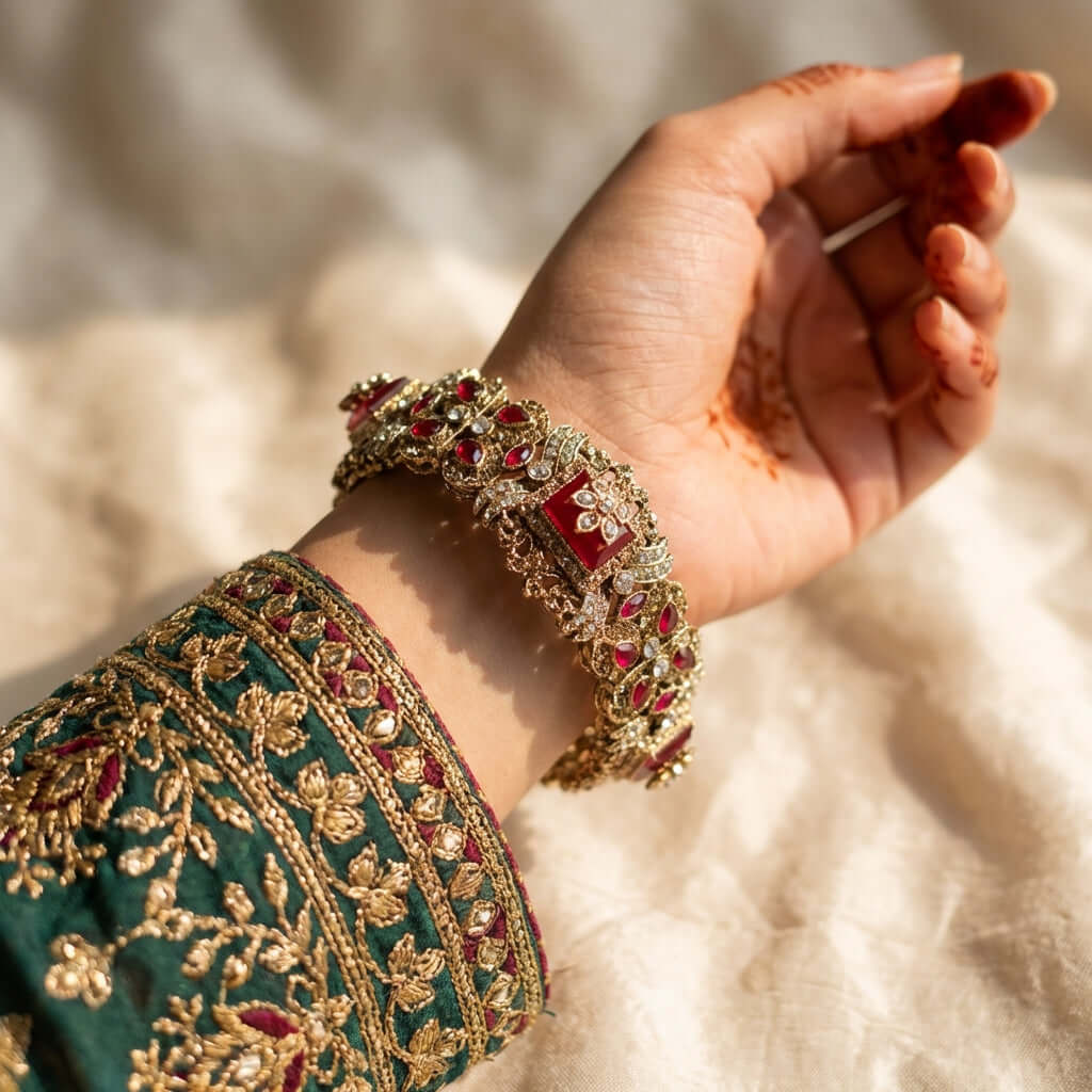 Royal ruby kundan bridal bangle - Pakistani women's luxury bridal jewelry with deep ruby stones and crystal accents in gold tone front view
